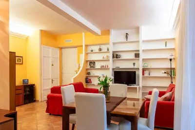 a living room with a red couch and a table at Casa Rio by Hili in Rome