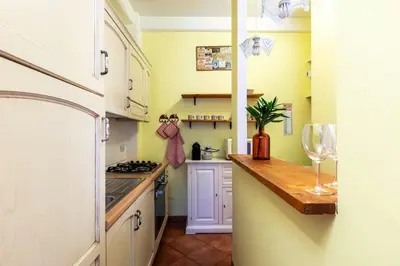 a kitchen with white cabinets and a counter top at Casa Rio by Hili in Rome