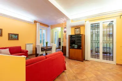 a living room with red couches and a table at Casa Rio by Hili in Rome