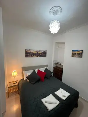 a bedroom with a black bed with red pillows at centro stazione tuscolana in Rome