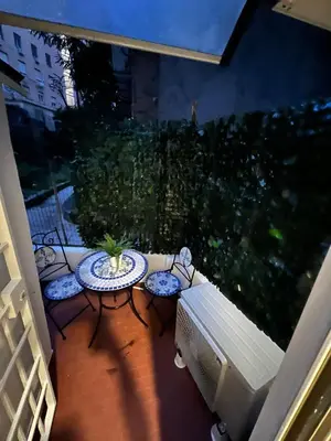 a patio with a table and chairs on a balcony at centro stazione tuscolana in Rome