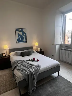 a bedroom with a large bed with flowers on it at Giant Cola di Rienzo Apartment in Rome
