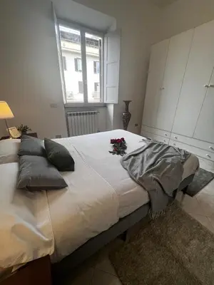 a bedroom with a large bed with flowers on it at Giant Cola di Rienzo Apartment in Rome