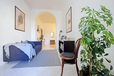 a bedroom with a blue bed and a potted plant at Giant Cola di Rienzo Apartment in Rome