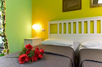 a bedroom with two beds with red roses on them at Best Rooms Termini in Rome
