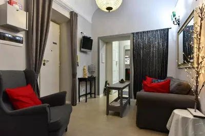 a living room with a couch and red pillows at Best Rooms Termini in Rome