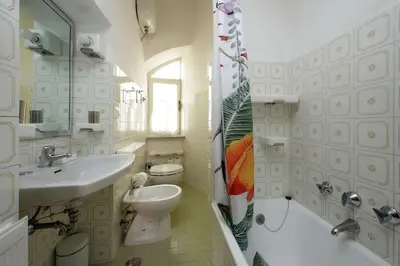 a bathroom with a sink and a toilet and a shower at Appartamento 