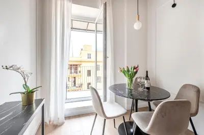 a dining room with a table and chairs and a window at W STUDIO TERMINI in Rome
