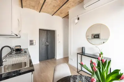 a kitchen with a sink and a table with a mirror at W STUDIO TERMINI in Rome