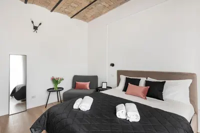 a bedroom with a large bed and a chair at W STUDIO TERMINI in Rome