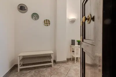 a white room with a table and a door at Tomo Apartment St. Peter's in Rome
