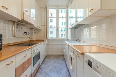 a white kitchen with a sink and a dishwasher at Tomo Apartment St. Peter's in Rome