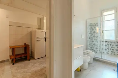 a kitchen with a white refrigerator and a toilet at Tomo Apartment St. Peter's in Rome