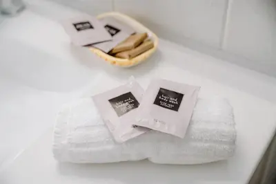 a pile of towels on a counter with a basket at Luisa Flat - Metro Basilica San Paolo - Wi-Fi in Rome