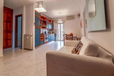 a living room with a couch and a kitchen at Luisa Flat - Metro Basilica San Paolo - Wi-Fi in Rome