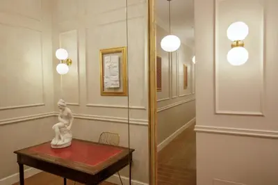 a statue sitting on a table in a room at Daplace - Santa Susanna Suites in Rome
