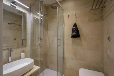 a bathroom with a glass shower and a sink at Daplace - Santa Susanna Suites in Rome