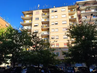 a tall building with cars parked in front of it at Appartamento Hector in Rome