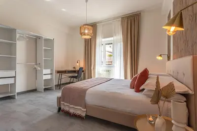 a bedroom with a large bed and a desk at CORNELIA COZY&ELEGANCE FLAT in Rome