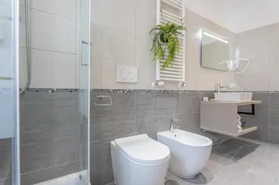 a bathroom with a toilet and a sink and a shower at CORNELIA COZY&ELEGANCE FLAT in Rome