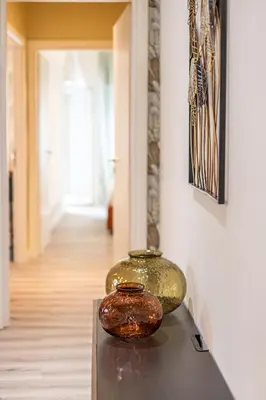 a couple of vases sitting on top of a table at CORNELIA COZY&ELEGANCE FLAT in Rome