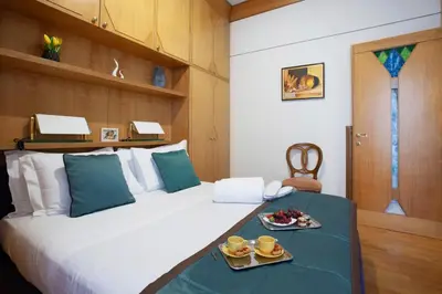 a bedroom with a bed with two plates of food on it at Harry's Bar Trevi Luxury Apartments - Sardegna in Rome