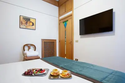 a room with a bed with two plates of food on it at Harry's Bar Trevi Luxury Apartments - Sardegna in Rome