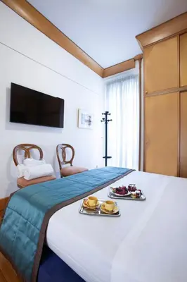 a large bed with two plates of food on it at Harry's Bar Trevi Luxury Apartments - Sardegna in Rome