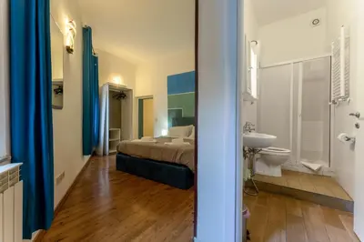 a bedroom with a bed and a sink and a toilet at Pellegrino Apartments in Rome