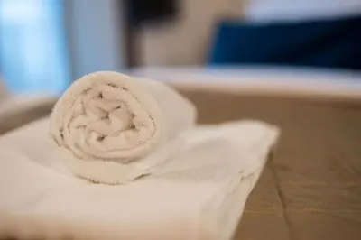 a roll of white towels sitting on top of a table at Pellegrino Apartments in Rome