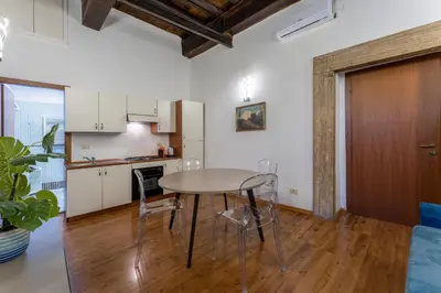 a kitchen and dining room with a table and chairs at Pellegrino Apartments in Rome