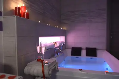 a bathroom with a tub with red candles and red candles at Apartment Nido di Roma Suite, Jacuzzi King Size, Metro C in Rome