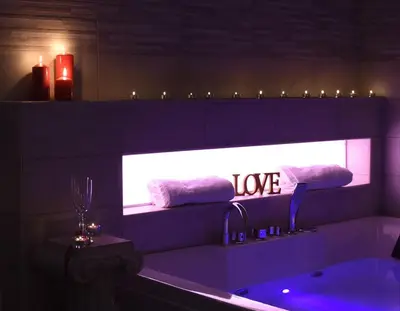 a bathroom with a bath tub with a sign that says love at Apartment Nido di Roma Suite, Jacuzzi King Size, Metro C in Rome