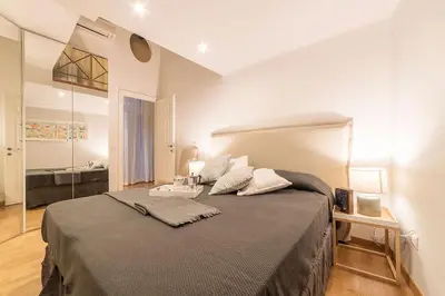a bedroom with a large bed and a bathroom at Campo De' Fiori 35 (Centro di Roma/Appartamento accogliente) - FromhometoRome in Rome
