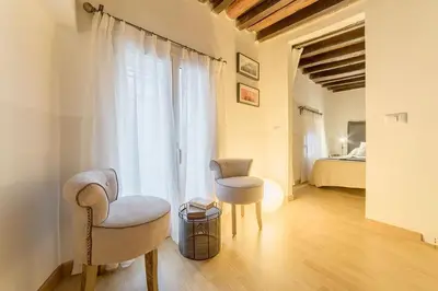 a living room with two chairs and a bed at Campo De' Fiori 35 (Centro di Roma/Appartamento accogliente) - FromhometoRome in Rome