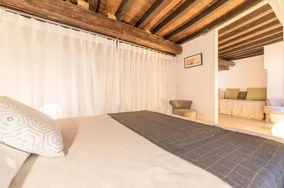 a bedroom with a large bed and a couch at Campo De' Fiori 35 (Centro di Roma/Appartamento accogliente) - FromhometoRome in Rome