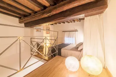 a bedroom with a bed and two chairs in a room at Campo De' Fiori 35 (Centro di Roma/Appartamento accogliente) - FromhometoRome in Rome