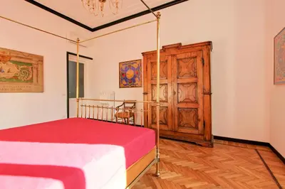 a bedroom with a bed and a wooden door at Tibullo ,Classico ed Elegante Appartamento in Rome