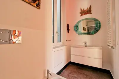 a bathroom with a sink and a mirror at Tibullo ,Classico ed Elegante Appartamento in Rome