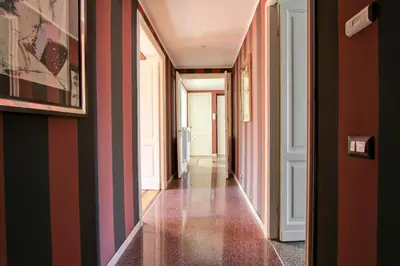 a hallway with red and black striped walls at Tibullo ,Classico ed Elegante Appartamento in Rome