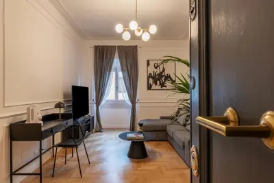 a living room with a couch and a table at Toscana 6 - FromhometoRome in Rome