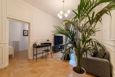 a living room with a potted plant and a desk at Toscana 6 - FromhometoRome in Rome