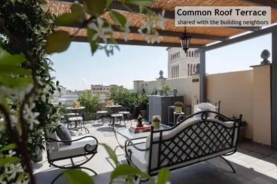 a patio with tables and chairs and a building at Toscana 6 - FromhometoRome in Rome