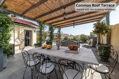 a patio with a table and chairs on a balcony at Toscana 6 - FromhometoRome in Rome