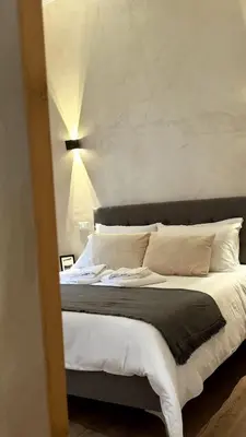 a bedroom with a large bed with white sheets and pillows at Ten Miles Guesthouse Roma in Rome