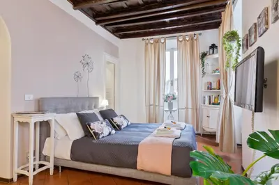 a bedroom with a bed and a television in it at Rome As You Feel - Santo Stefano in Rome