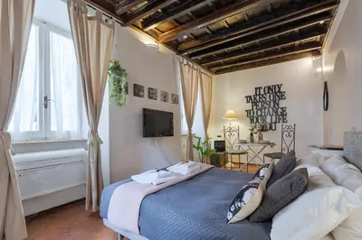 a bedroom with a large bed and a tv at Rome As You Feel - Santo Stefano in Rome