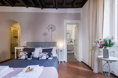 a bedroom with a blue bed with flowers on it at Rome As You Feel - Santo Stefano in Rome