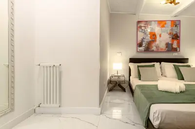 a bedroom with a bed and a table with towels at Crispi 30 Stylish Apartment in Rome