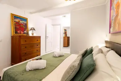 a bedroom with a large bed with two pillows on it at Crispi 30 Stylish Apartment in Rome